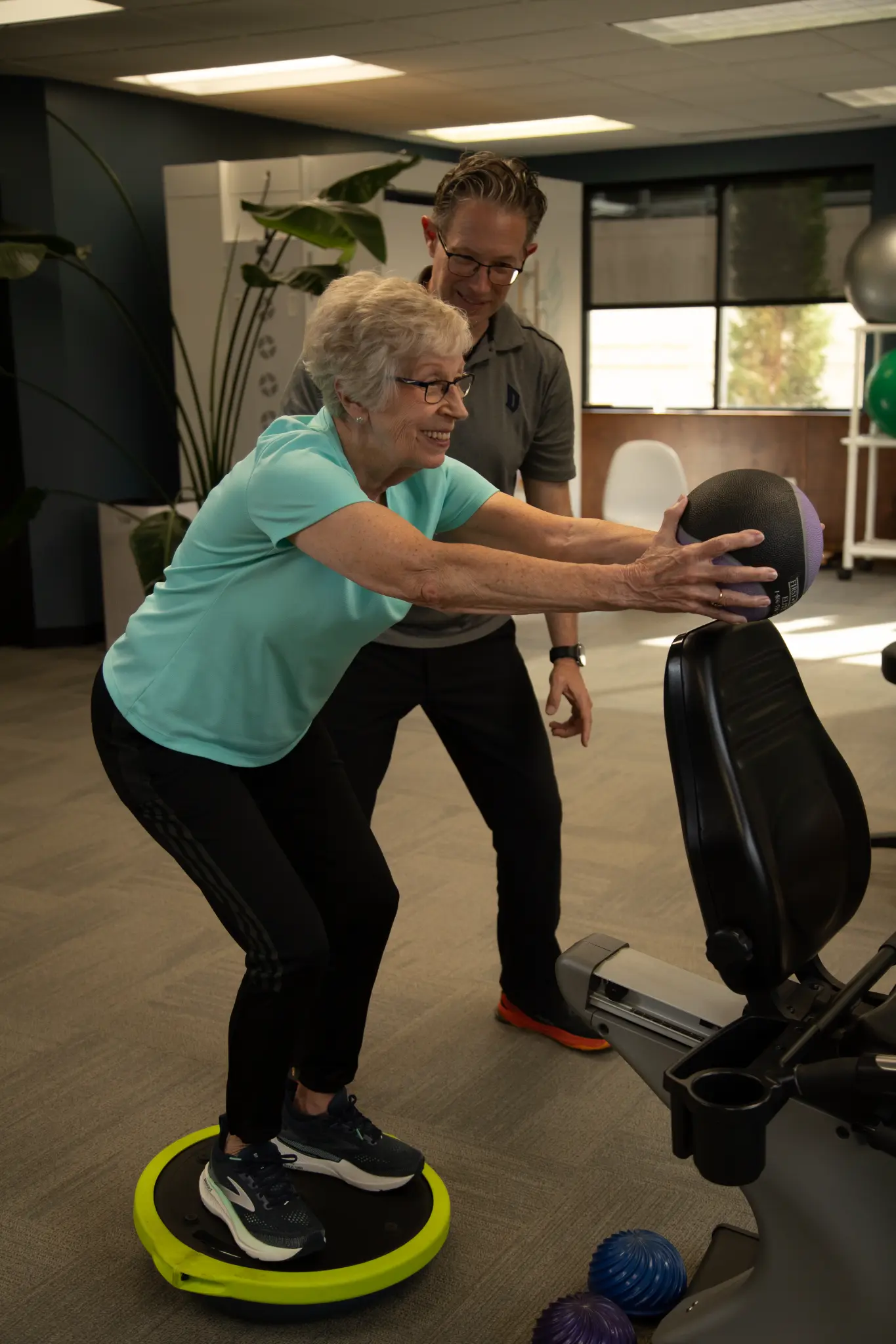 Aaron McBride coaching a client through a balance and strength exercise during Personal Training at MARC